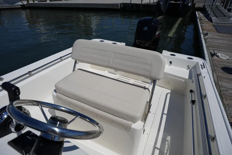 Slide: The Image of 2025 Boston Whaler 170 Montauk boat interior with steering wheel and seating. - 14