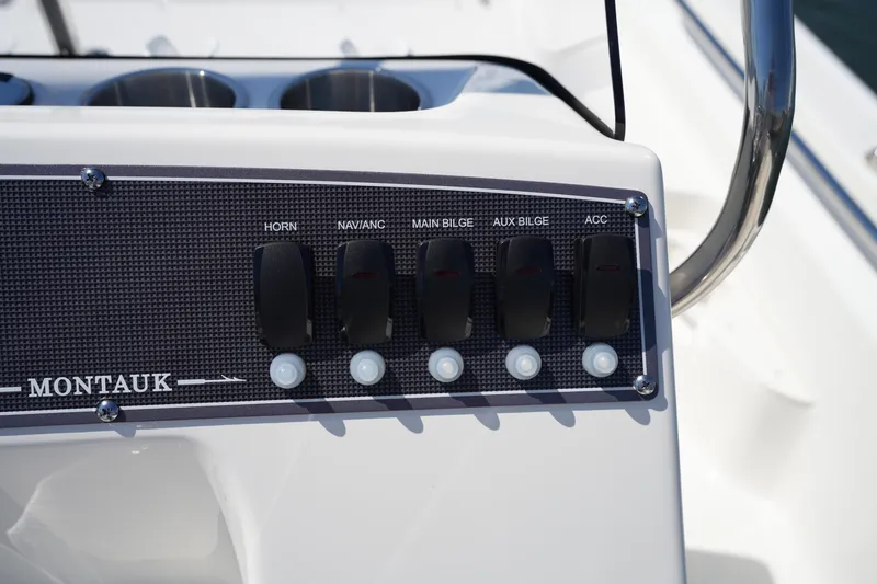 Slide: The Image of Control panel of 2025 Boston Whaler 170 Montauk boat with labeled switches. - 16