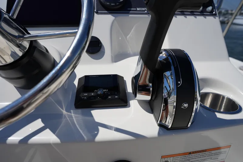 Slide: The Image of 2025 Boston Whaler 170 Montauk helm with steering wheel and control panel. - 18