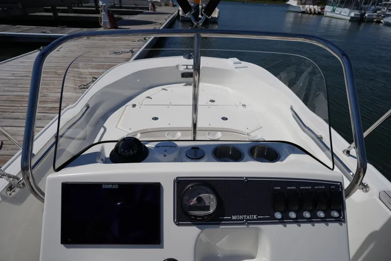 Slide: The Image of 2025 Boston Whaler 170 Montauk boat dashboard with controls and navigation equipment. - 19