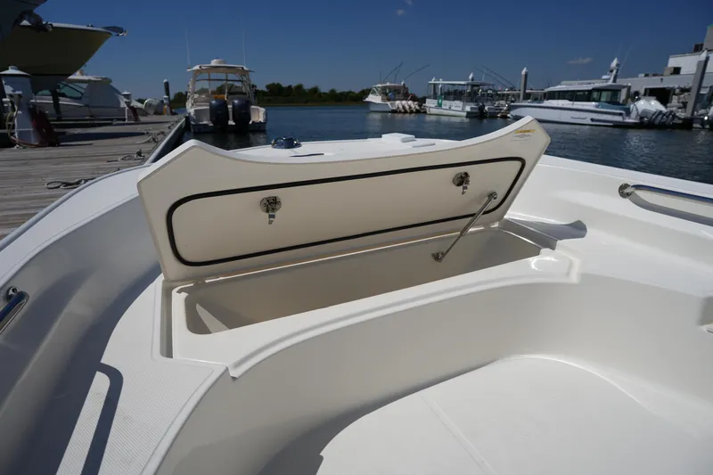 Slide: The Image of 2025 Boston Whaler 170 Montauk boat storage compartment open at marina. - 22