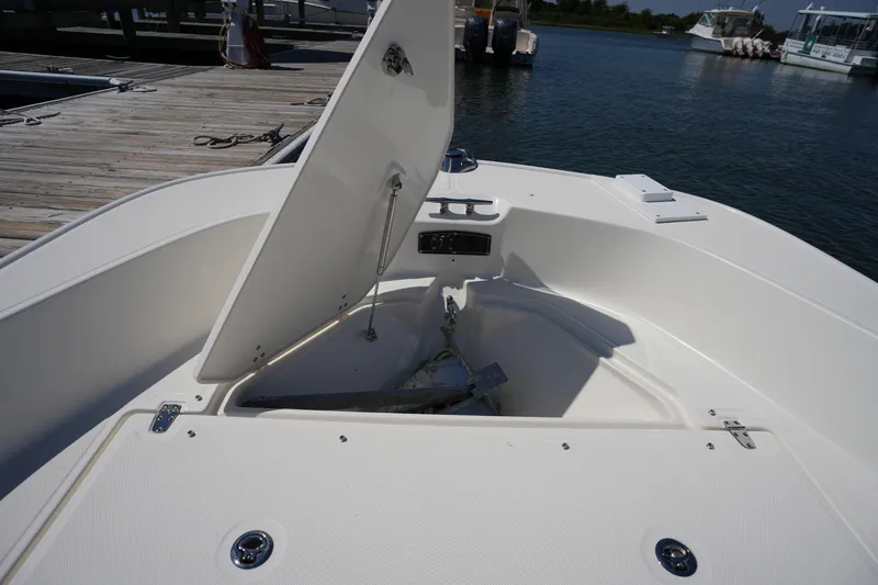 Slide: The Image of 2025 Boston Whaler 170 Montauk boat with open anchor storage at dock. - 23