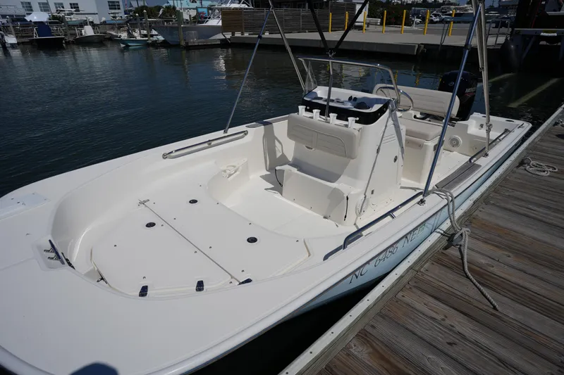 Slide: The Image of 2025 Boston Whaler 170 Montauk boat docked at marina, showcasing spacious interior. - 24