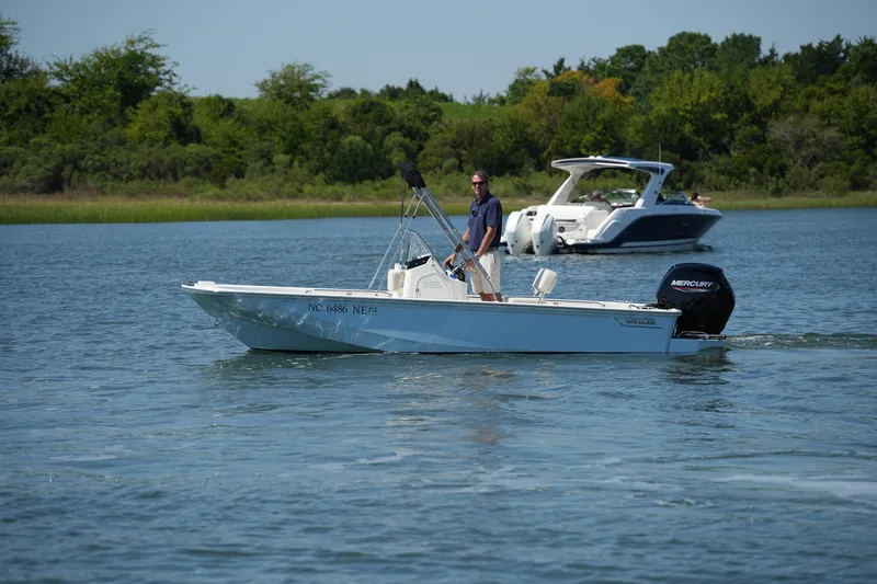 Slide: The Image of 2025 Boston Whaler 170 Montauk boat cruising on a serene lake. - 3