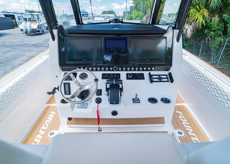 Slide: The Image of 2024 Fountain 32 NX boat dashboard with modern controls and dual screens. - 20