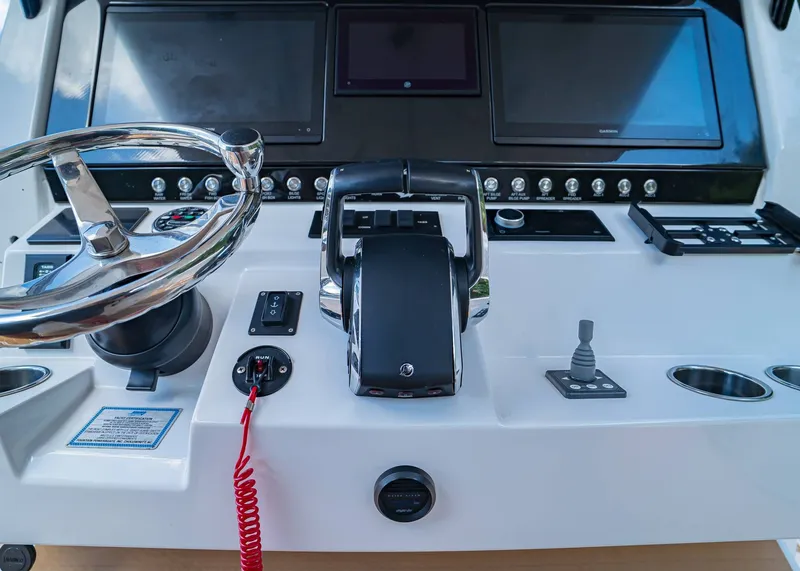 Slide: The Image of 2024 Fountain 32 NX boat dashboard with steering wheel and control panel. - 22