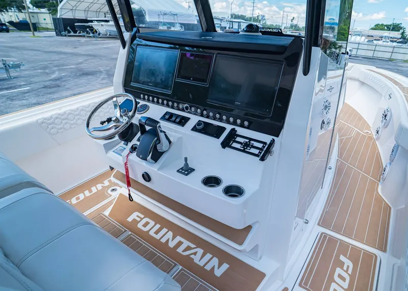 Slide: The Image of 2024 Fountain 32 NX boat cockpit with advanced navigation controls and sleek design. - 23