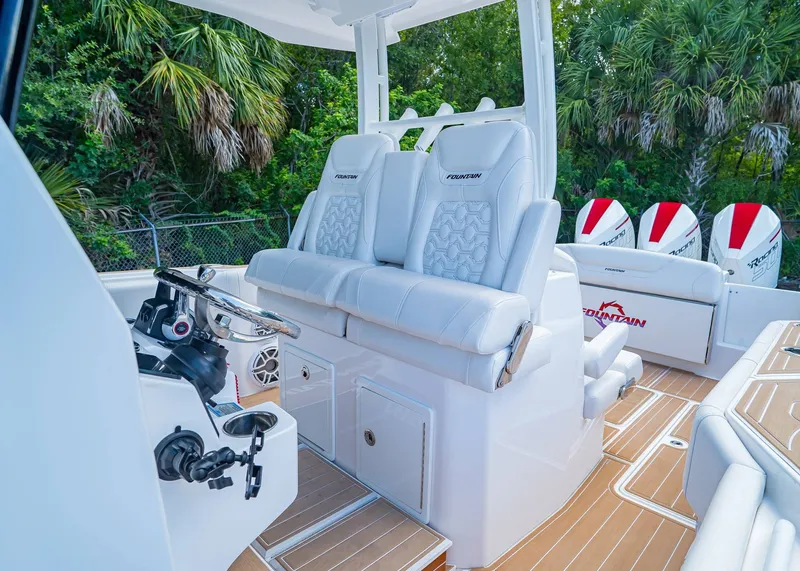 Slide: The Image of 2024 Fountain 32 NX boat interior with luxurious seating and modern controls. - 25