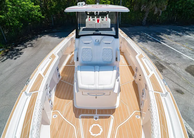Slide: The Image of 2024 Fountain 32 NX boat with sleek white seating and wood-patterned deck. - 33