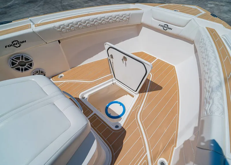 Slide: The Image of 2024 Fountain 32 NX boat interior with teak flooring and storage compartment. - 34
