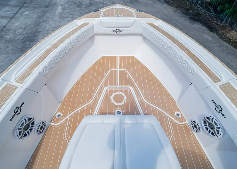 Slide: The Image of 2024 Fountain 32 NX boat deck with teak flooring and cushioned seating. - 35