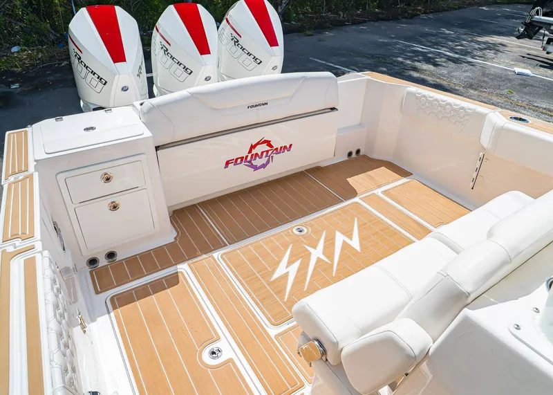 Slide: The Image of 2024 Fountain 32 NX boat interior with triple engines and teak flooring. - 5