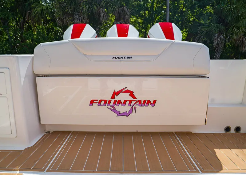 Slide: The Image of 2024 Fountain 32 NX boat with logo, featuring sleek seating and teak flooring. - 6