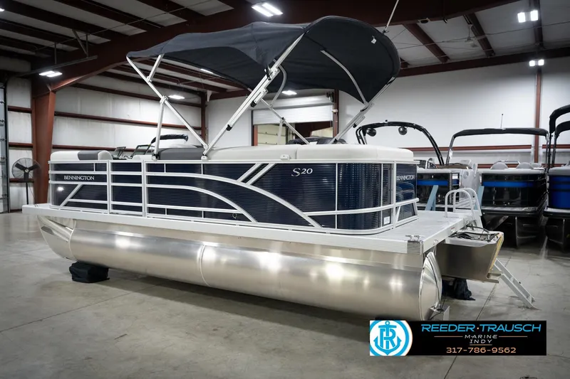 Slide: The Image of 2026 Bennington 20 SL pontoon boat in showroom with canopy and sleek design. - 10