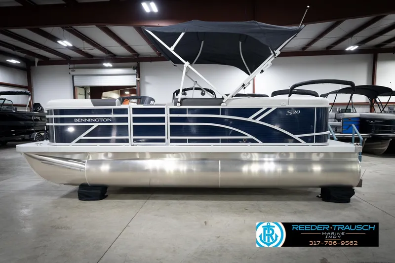 Slide: The Image of 2026 Bennington 20 SL pontoon boat with canopy in showroom setting. - 11