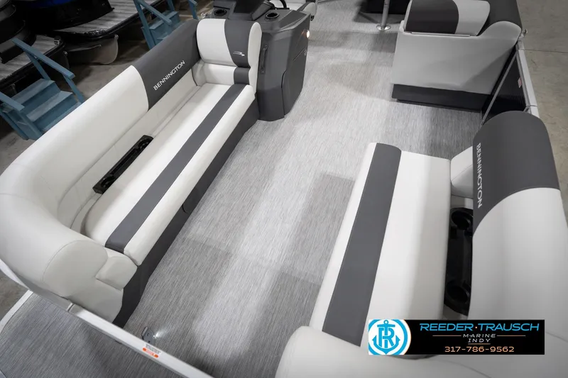 Slide: The Image of 2026 Bennington 20 SL pontoon boat interior with gray and white seating, Reeder-Trausch Marine logo. - 12