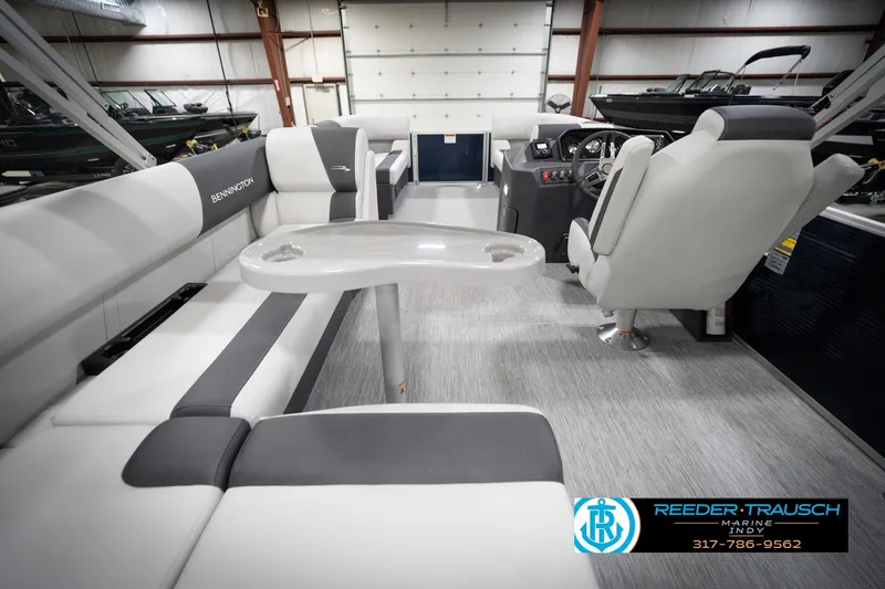 Slide: The Image of 2026 Bennington 20 SL pontoon boat interior with plush seating and modern helm. - 19