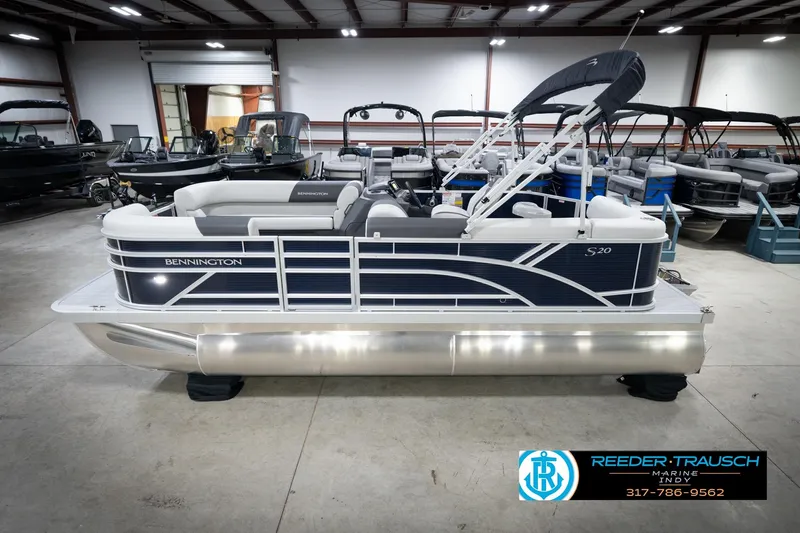The Image of 2026 Bennington 20 SL pontoon boat in showroom, side view, with sleek design and modern features. - 2