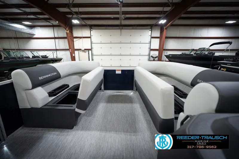 Slide: The Image of 2026 Bennington 20 SL pontoon boat interior in showroom, featuring spacious seating. - 22