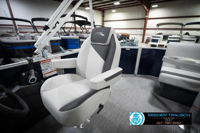 Slide: The Image of 2026 Bennington 20 SL boat interior with modern seating in a showroom. - 24