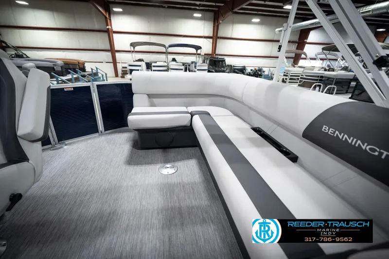 Slide: The Image of 2026 Bennington 20 SL pontoon boat interior with gray seating in showroom. - 26
