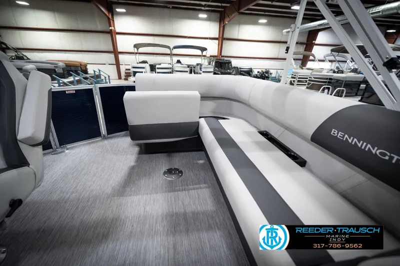Slide: The Image of 2026 Bennington 20 SL pontoon boat interior with sleek seating in a showroom. - 28