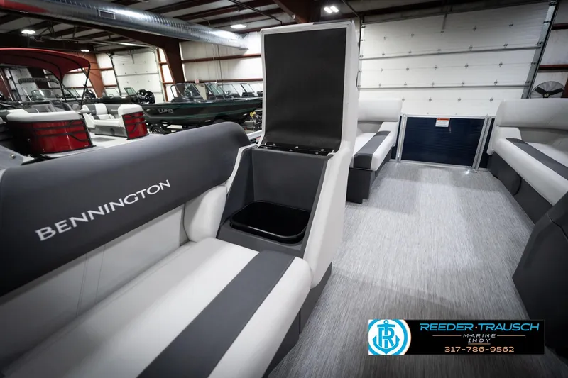 Slide: The Image of 2026 Bennington 20 SL pontoon boat interior with open storage compartment in showroom. - 30