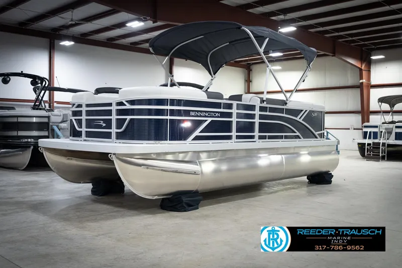 Slide: The Image of 2026 Bennington 20 SL pontoon boat in showroom with canopy and sleek design. - 4