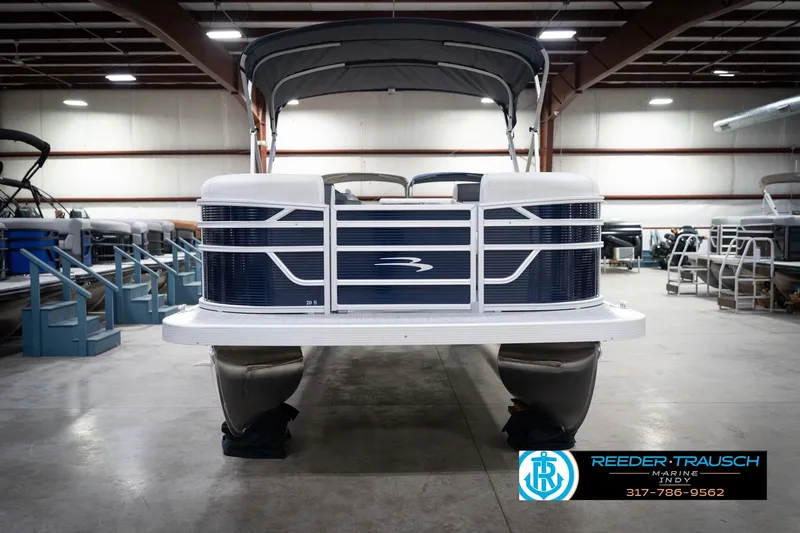 Slide: The Image of 2026 Bennington 20 SL pontoon boat in showroom, featuring sleek design and canopy. - 5