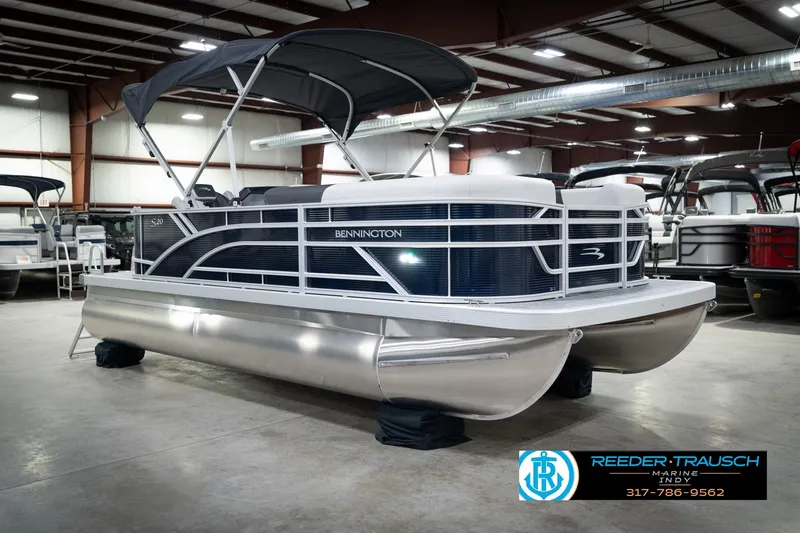 Slide: The Image of 2026 Bennington 20 SL pontoon boat in showroom, featuring sleek design and canopy. - 6