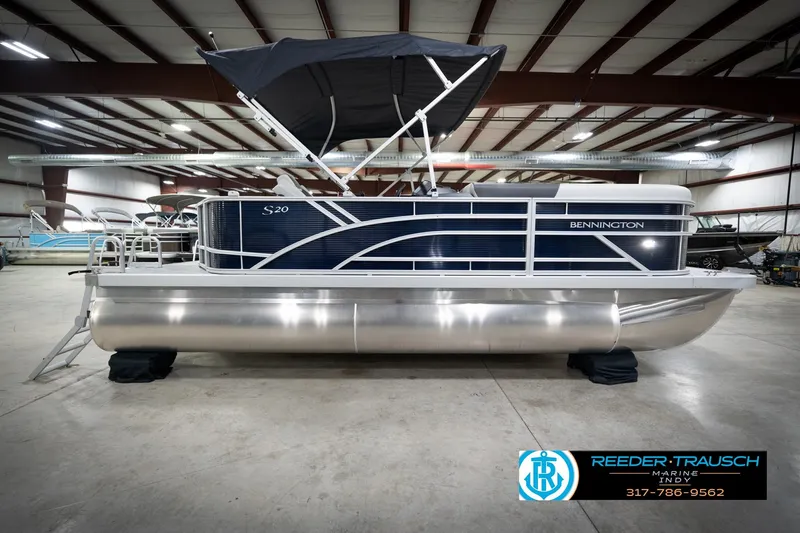 Slide: The Image of 2026 Bennington 20 SL pontoon boat in indoor showroom with canopy. - 7