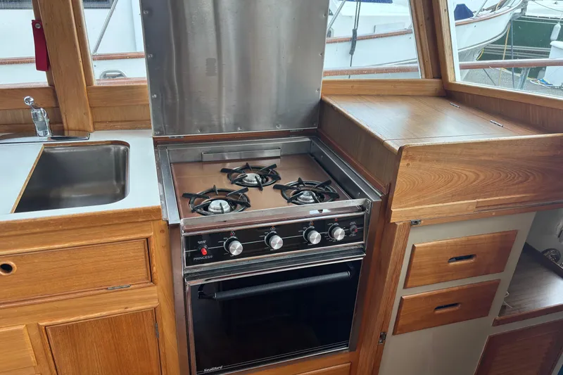 Slide: The Image of 1991 Grand Banks 36 Classic yacht kitchen with stove, oven, and sink. - 12