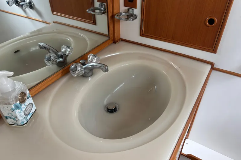 Slide: The Image of Bathroom sink with chrome faucet on 1991 Grand Banks 36 Classic yacht. - 16