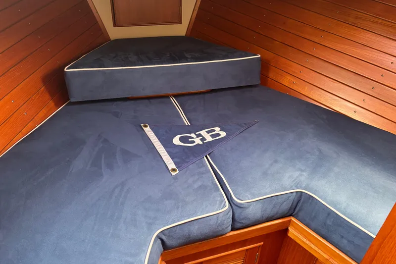 Slide: The Image of Cozy cabin interior of 1991 Grand Banks 36 Classic with blue cushions and wood paneling. - 18