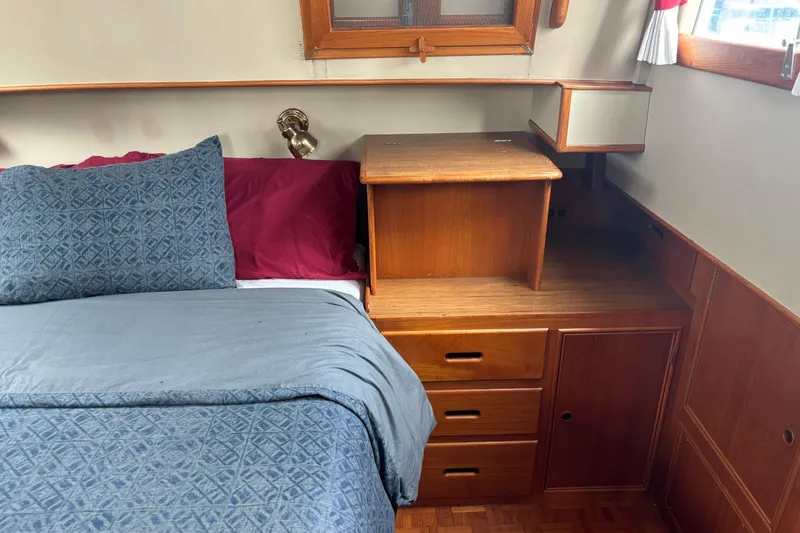 Slide: The Image of Cozy cabin interior of 1991 Grand Banks 36 Classic with wooden furniture and bedding. - 21