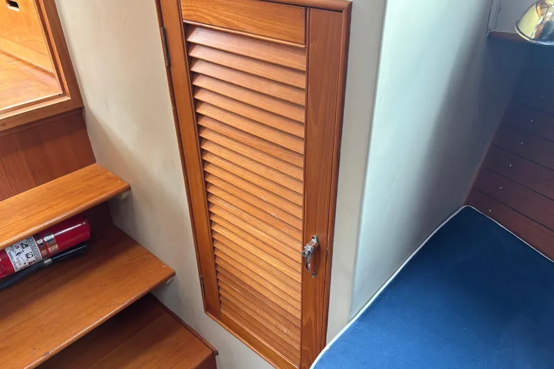 Slide: The Image of Interior of 1991 Grand Banks 36 Classic with wooden stairs and louvered door. - 24