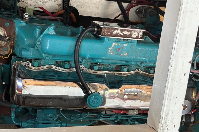 Slide: The Image of Engine of a 1991 Grand Banks 36 Classic boat, featuring a turquoise and chrome finish. - 25