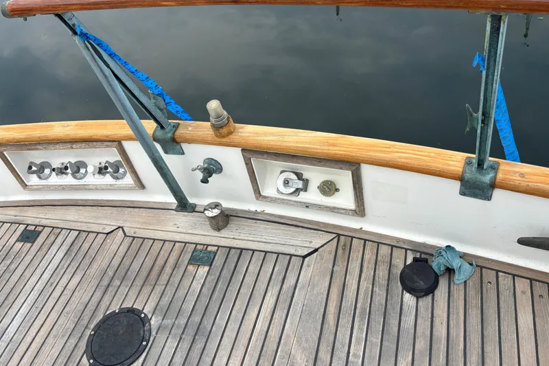Slide: The Image of 1991 Grand Banks 36 Classic boat deck with wooden railing and nautical equipment. - 6