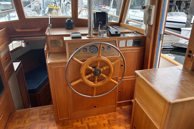 Slide: The Image of Helm of 1991 Grand Banks 36 Classic yacht with wooden steering wheel and navigation instruments. - 7