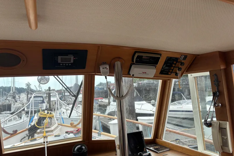 Slide: The Image of Interior view of 1991 Grand Banks 36 Classic yacht cockpit with marina background. - 9