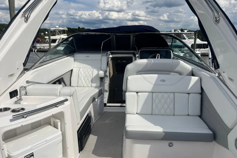 Slide: The Image of 2023 Regal 28 Express boat interior with white seating and modern amenities. - 10