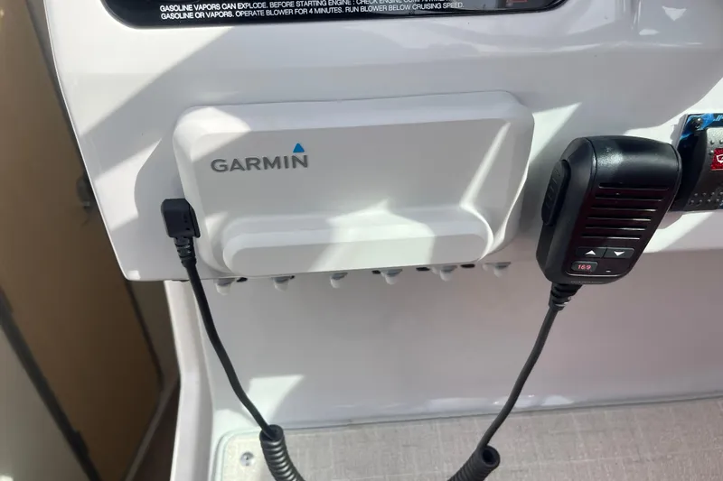 Slide: The Image of Garmin device and microphone on 2023 Regal 28 Express boat dashboard. - 20