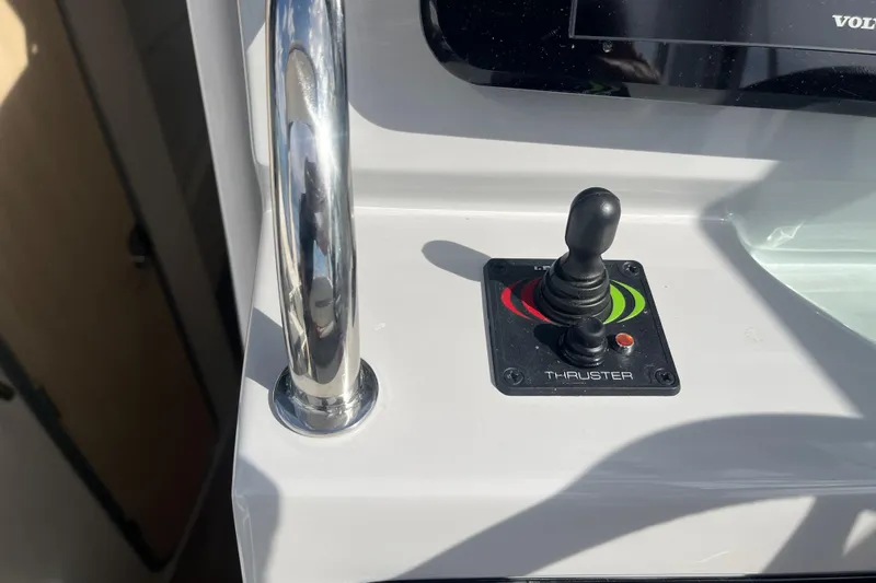 Slide: The Image of 2023 Regal 28 Express boat thruster control with joystick and chrome handle. - 21