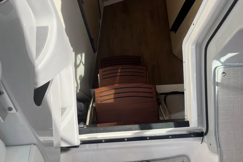 Slide: The Image of 2023 Regal 28 Express cabin entrance with wooden steps and modern interior. - 24