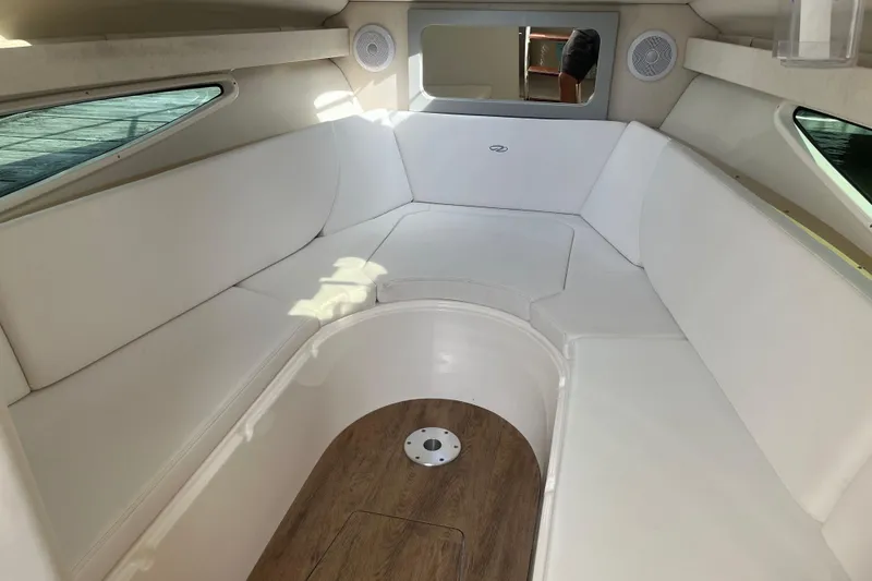 Slide: The Image of 2023 Regal 28 Express cabin interior with white seating and wood flooring. - 25