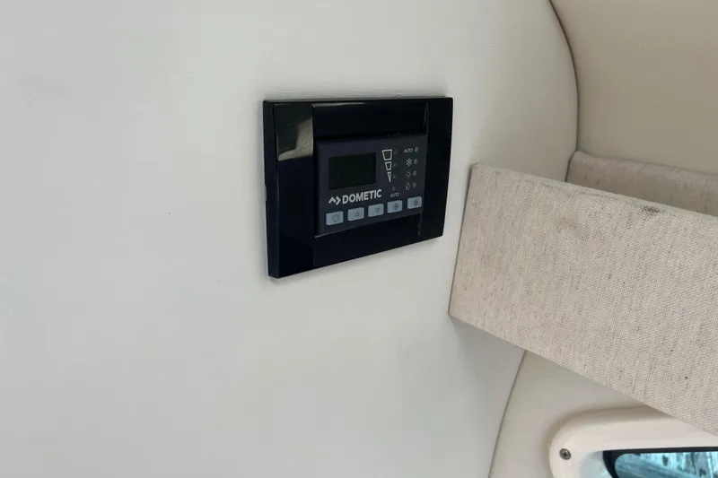 Slide: The Image of Dometic control panel inside 2023 Regal 28 Express boat cabin. - 37