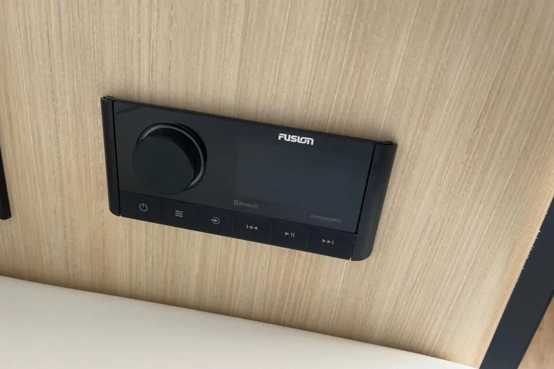 Slide: The Image of Fusion audio control panel on 2023 Regal 28 Express boat interior. - 38