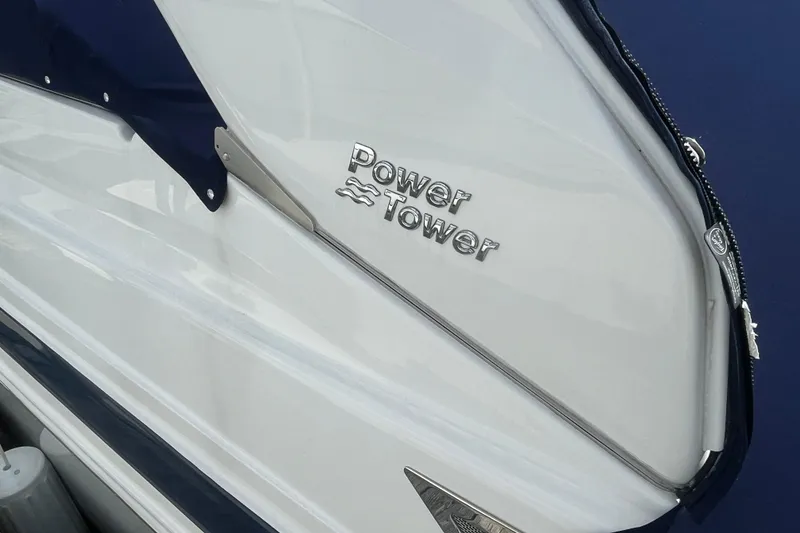 Slide: The Image of 2023 Regal 28 Express boat with "Power Tower" feature, sleek white and blue design. - 4