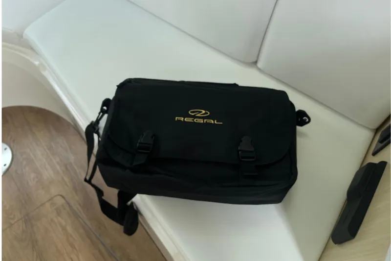 Slide: The Image of Black Regal bag on a white seat inside a 2023 Regal 28 Express boat. - 41