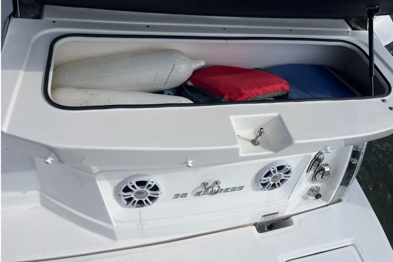 Slide: The Image of 2023 Regal 28 Express boat storage compartment with fenders and life jackets. - 8